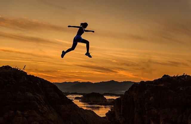 Figure jumping across mountains