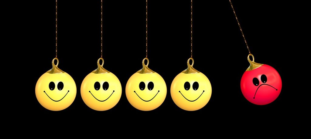 Smiley face balls, with one sad faced ball